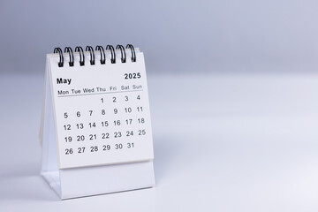 May 2025 calendar - month page on white desk