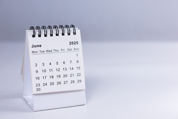 June 2025 calendar - month page on white desk
