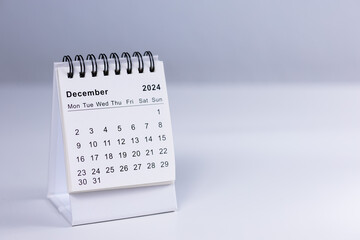 December 2024 calendar - month page on white desk