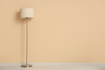 Floor lamp near beige wall in room