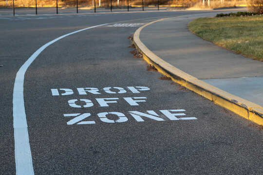 close-up of drop off zone words on asphalt for city planning transporation funding education community parks and recreation backgrounds