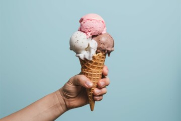 Sweet Summer Treat: A refreshing ice cream cone with three scoops, held in hand against a vibrant, captivating backdrop.