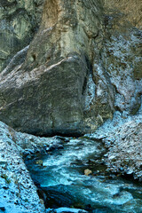 Fototapeta premium gorge with a river in winter in the mountains