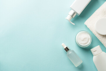 Natural cosmetic products on blue. Skin care products. Top view with copy space.