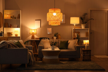 Interior of living room with sofas, coffee table and glowing lamps
