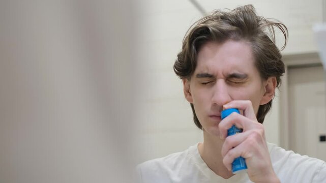 A man with a runny nose applies a means to irrigate and rinse the nasal cavity