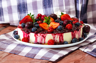 Traditional Christmas red fruit cheesecake with creative and luxurious decoration