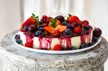 Traditional Christmas red fruit cheesecake with creative and luxurious decoration