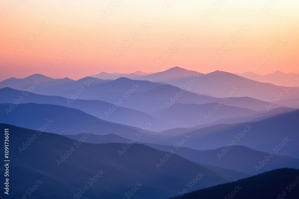 Poster layers of mountains stretch across the horizon at sunset, bathed in soft pastel hues creating a tran