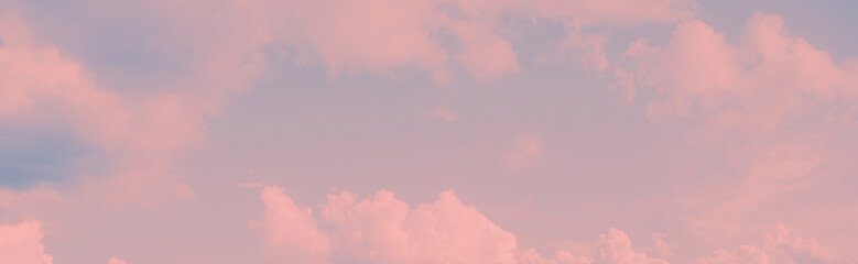 The romantic beautiful sky with delicate pink clouds at sunset creates a magical atmosphere of love.