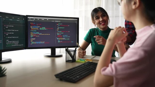 Slow motion back end software developer engineer for computer programming working together on debugging writing computing code, solving complex algorithms display on monitor in office. Burgeoning