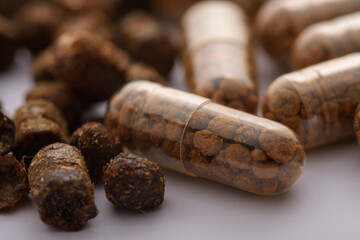 Macro photography of bee bread and biologically active supplement in capsules with bee pollen in high resolution