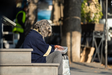Beggar old woman begging for money on the street
