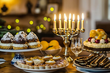 Fototapeta premium a traditional hanukkah desserts near illuminated menorah, intimate home setting