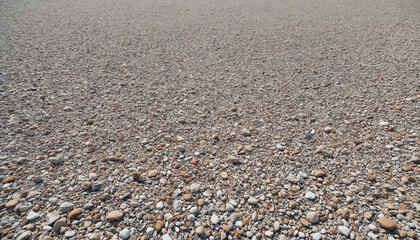 Gravelly ground covered with small pebbles in varied colors and textures