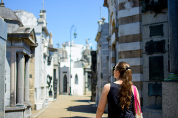 Fototapeta premium woman walking in the recoleta cemetery in buenos aires, argentina