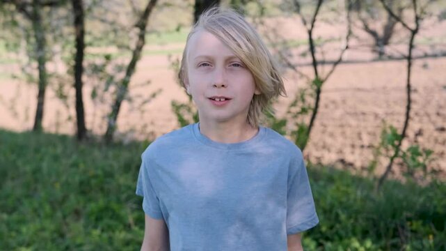 Young boy reacting with surprise and shock, holding his head in his hands, captures a moment of realization in slow motion