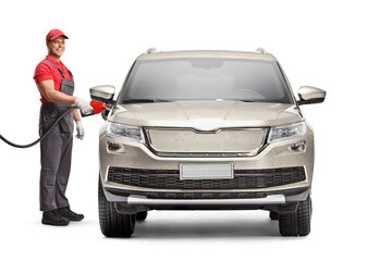 Petrol station worker filling a SUV with fuel