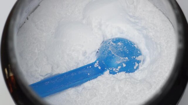Close up of a scoop in a creatine powder