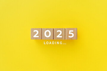 2025 New Year Loading. Loading bar with wooden blocks on yellow background. Start new year 2025...