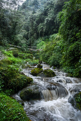 A small waterfall cascading through mountains of Nepal