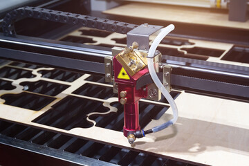 Laser CNC cutting wood. Modern machine industrial technology