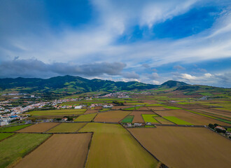 Sao Miguel Island scenic landscape with mountains and cultivated land in Azores, Portugal. Aerial drone view of panoramic Acores island