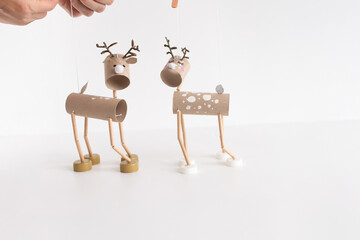Easy DIY reindeer marionette from toilet paper roll and recycled materials for kids. Perfect craft idea for children. Creative homemade toy project