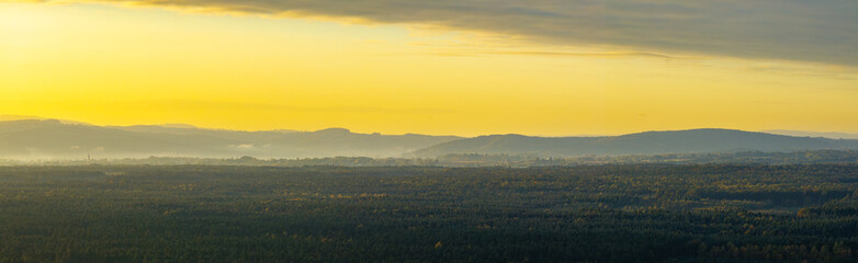 Golden Sunrise over Misty Valley and Hills