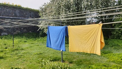Two towels in the colors of Ukraine on a clothesline