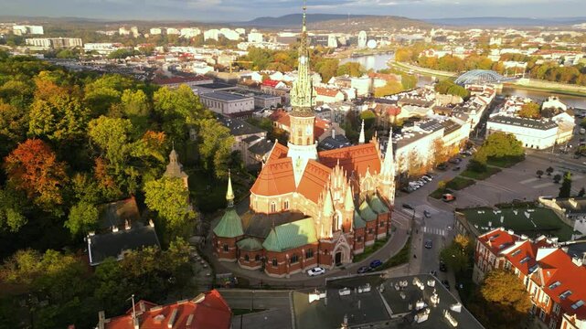 Aerial high angle top down footage oof St. Joseph's Church in Krakow, Poland. Sanktuarium Świętego J&oacute;zefa  Krakowie shot from the air. Sunrise around the autumn trees of polish city.  Close up.
