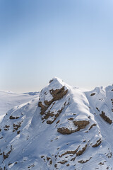 Snow-Covered Mountain Peaks Under a Clear Blue Sky