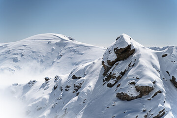 Snow-Covered Mountain Peaks Under a Clear Blue Sky