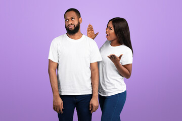 Obraz premium Relationship Problem Concept. Portrait of African American couple arguing, angry displeased black woman yelling at annoyed boyfriend who ignoring her, isolated over blue studio background