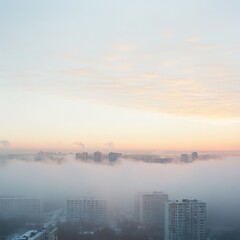 Fototapeta premium Mist over cityscape at dawn with soft light