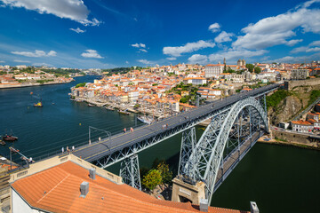 View of Porto city and Douro river with moored sailing ship and Dom Luis bridge I from famous tourist viewpoint Miradouro da Serra do Pilar on sunset. Porto, Vila Nova de Gaia, Portugal