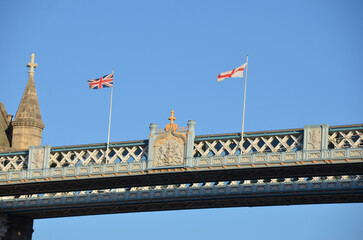 Flags of the United Kingdom and England at the top of Tower Bridge