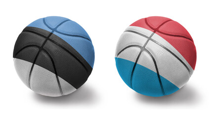 Fototapeta premium basketball balls with the national flags of luxembourg and estonia on the white background.