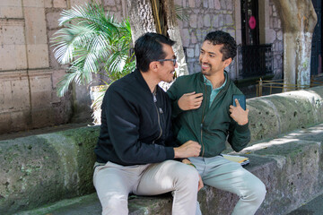Pareja gay compartiendo una risa auténtica, mostrando su amor en un día soleado.