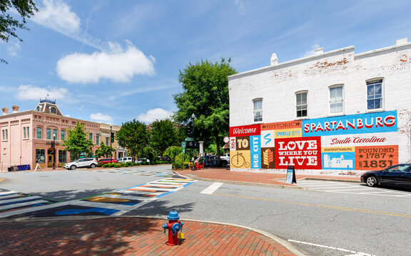 SPARTANBURG, SC, USA-13 JUNE 2021:  The heart of downtown, showing painted building welcome sign, Victorian building on the left of Boulevard.