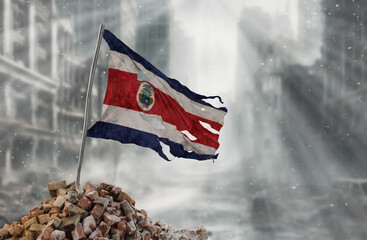 Dirty and torn Costa Rica flag, symbol of resistance and victory. A scene of war and devastation, the ruins of a city destroyed by conflicts. 3D Rendering.