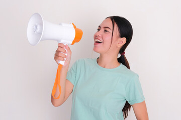 Closeup portrait of a woman speaking using megaphone with excited expression