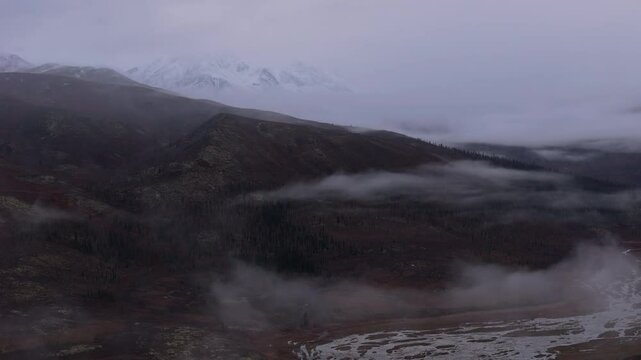 Clouds Engulfing Ogilvie Mountains Range In The Yukon Territory Of Northwestern Canada. Aerial Drone Shot