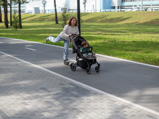 Caucasian woman roller skating with her toddler son in a stroller. 