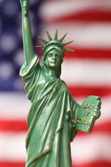 Fototapeta premium Statue of Liberty against flag of USA, closeup