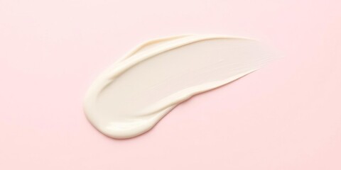 Fototapeta premium Creamy smear on a pale pink background with texture, gentle touch, natural ingredients, makeup application