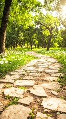 Fototapeta premium A serene stone pathway through a lush green park with blooming flowers.