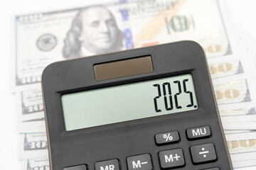 US Dollar banknotes, calculator and forecast for finances in 2025. Money, Budget, tax, investment,...