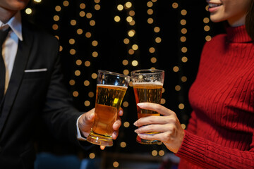 food and drink male friends are happy drinking beer and clinking glasses at a bar or pub.