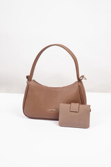 Women's brown handbag and wallet isolated on white background